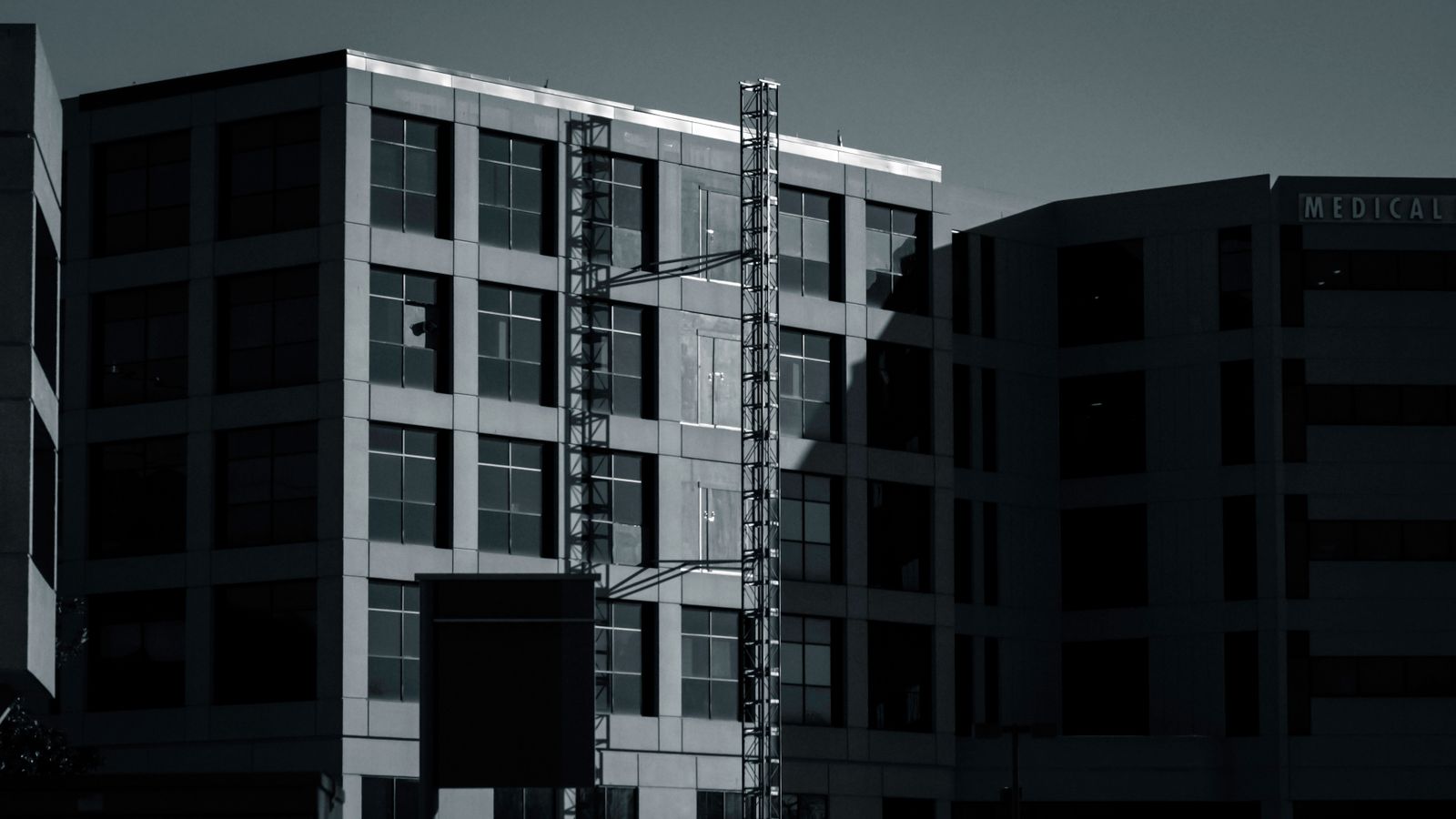 A shadowed facade of a modern medical building in Kentucky accentuating structural details.